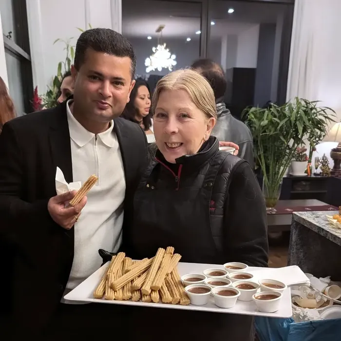 Elena serving churros with individual chocolate dipping cups