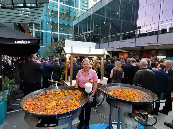 Elena serving paella at a busy city event