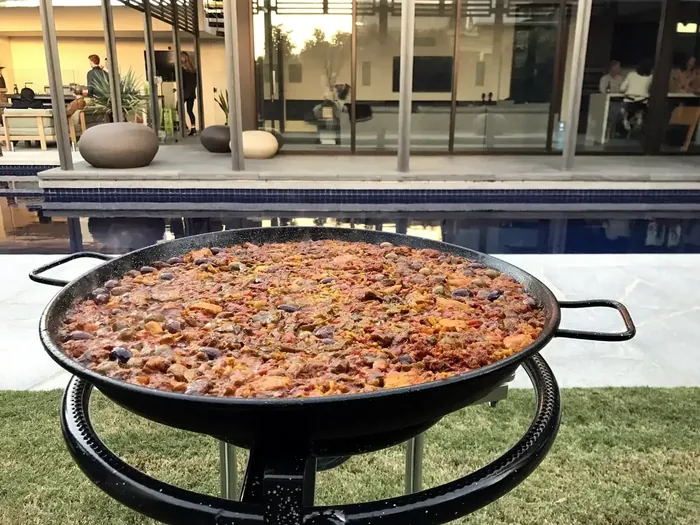 Large freshly cooked paella prepared for an outdoor event