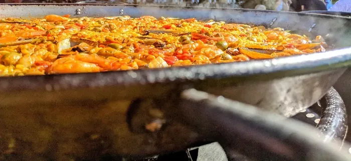 Close-up of paella and caramelised socarrat at the edge of the pan