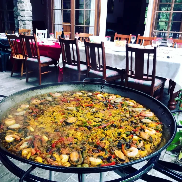 Seafood paella prepared for guests at a restaurant gathering