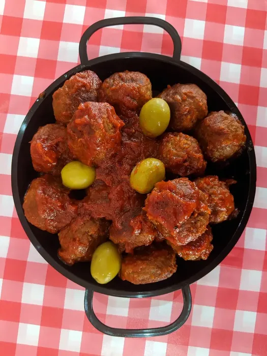 Spanish meatballs served with olives and lime
